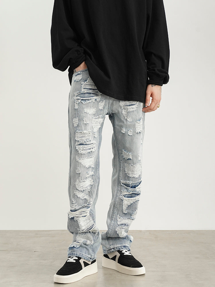 Jeans con lavado desgastado y parche de destrucción para hombres